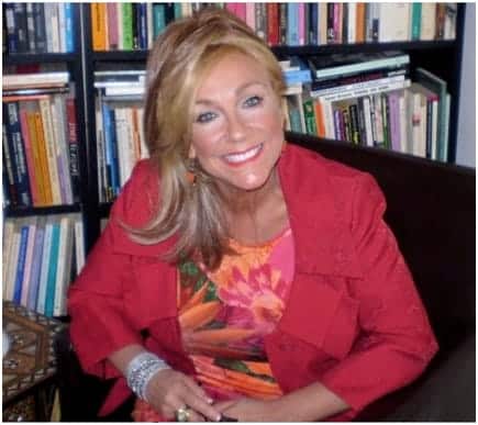 Helen Mia Harris Sitting on a chair in front of a bookshelf