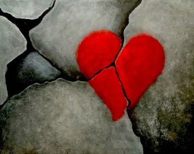 Cracked stone with a red heart symbol, symbolizing emotional healing and relationship work