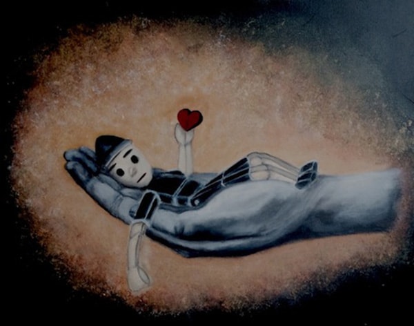 Wooden puppet lying in a large hand, holding a small red heart, symbolizing vulnerability, emotional dependence, and care.